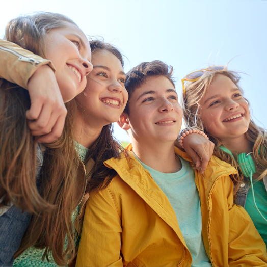 Group of happy teenage students or friends outdoors